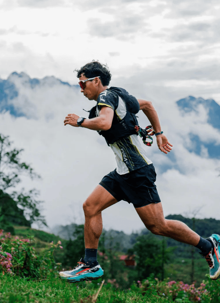 Trail runner striding through an alpine landscape